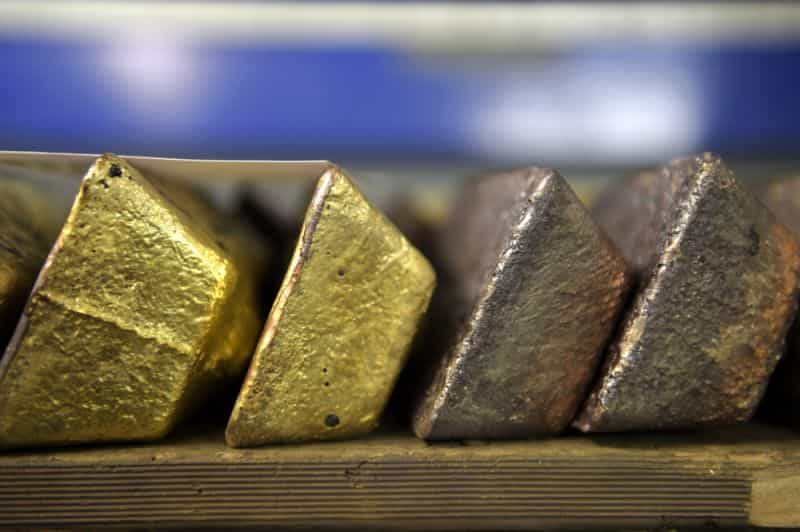 Gold steadies as dollar dip offsets pressure from hawkish Fed